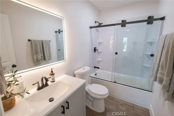 a bathroom with a sink toilet and shower