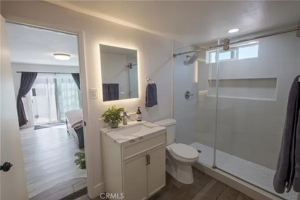 a bathroom with a sink a toilet and shower
