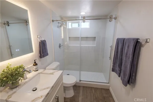 a bathroom with a sink toilet and shower