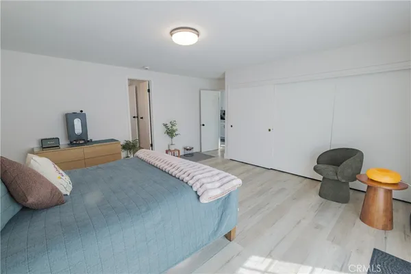 a bedroom with a bed and dresser