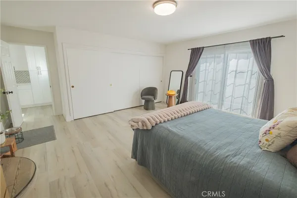 a bedroom with a bed and a large mirror