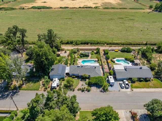an aerial view of a house with outdoor space and lake view