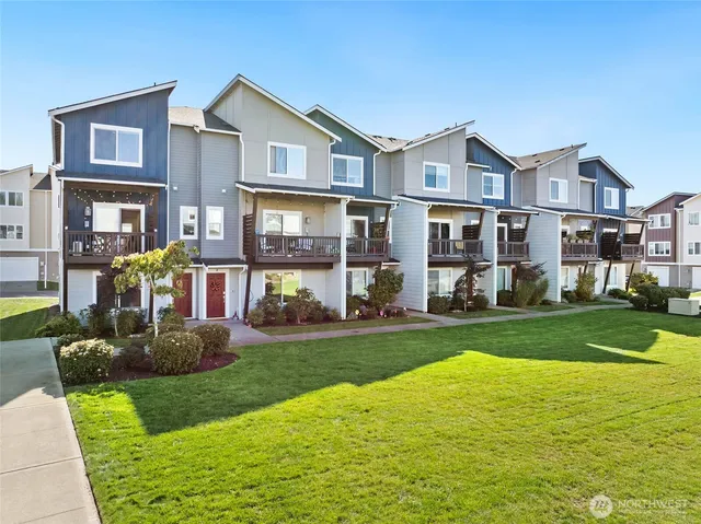 a front view of a house with a yard table and chairs
