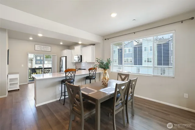a view of a dining room with furniture window and wooden floor
