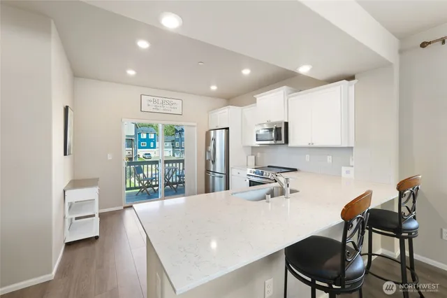 a kitchen with kitchen island a table and chairs in it