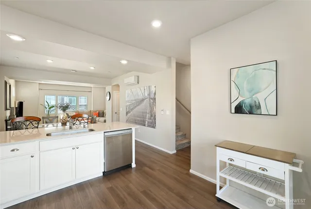 a kitchen with a sink cabinets and wooden floor