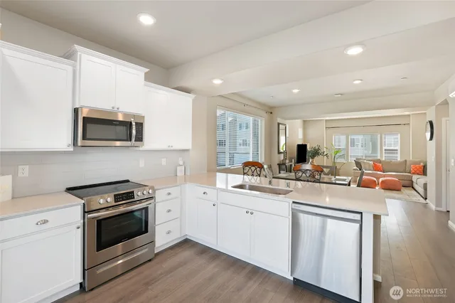a kitchen with a sink stove top oven and cabinets