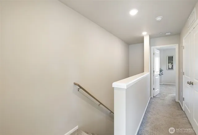 a view of a hallway with bathroom