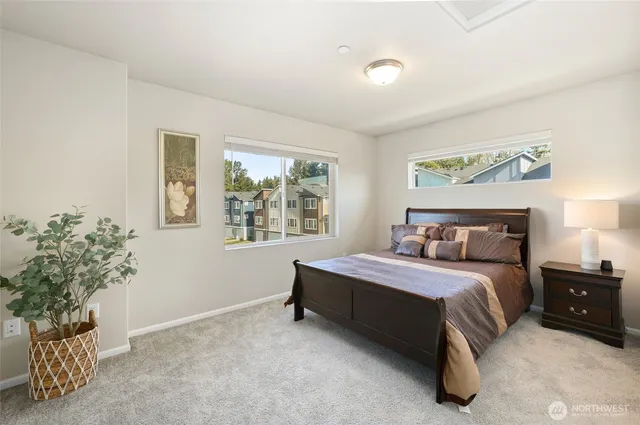 a spacious bedroom with a bed and a window