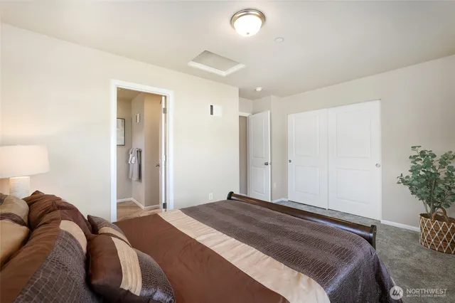 a bedroom with a bed and a potted plant