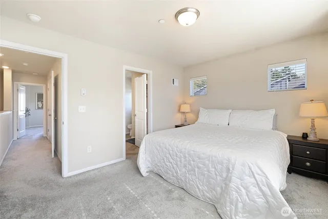 a bedroom with a bed and a view of bathroom