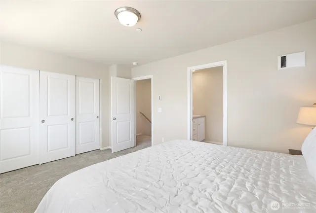 a bedroom with a bed and a bathroom