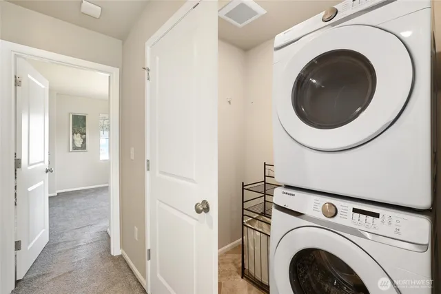 a view of a hallway with washer and dryer