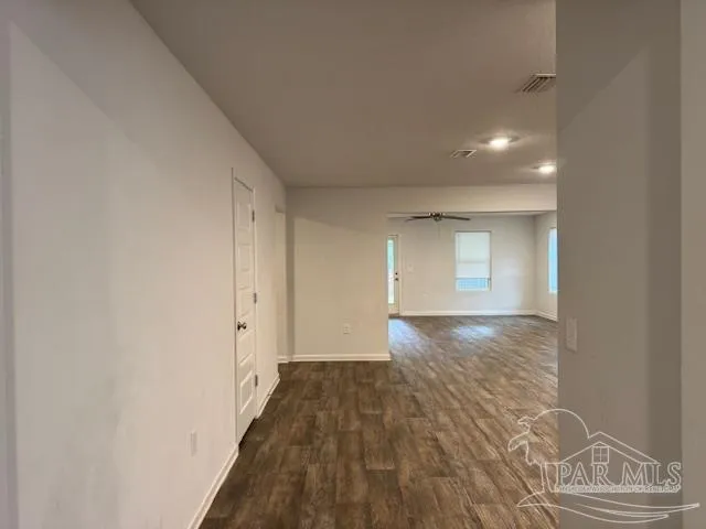 a view of an empty room and wooden floor