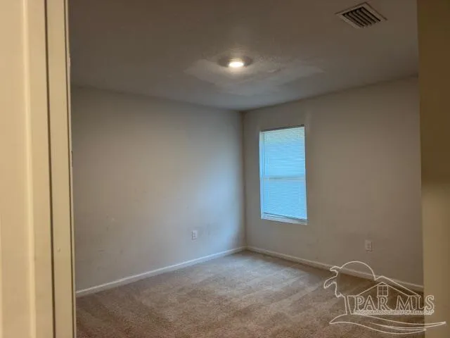 a view of an empty room and a window