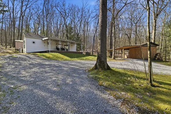 a view of a house with backyard and trees