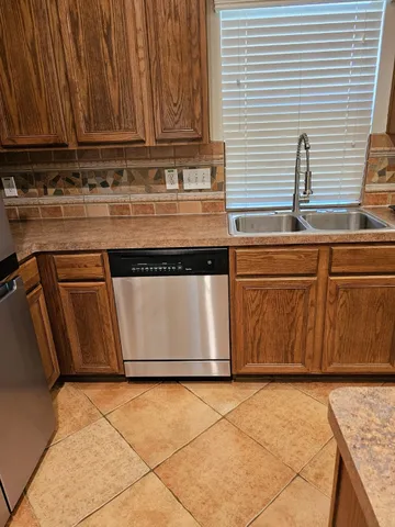 a kitchen with granite countertop a sink and a stove