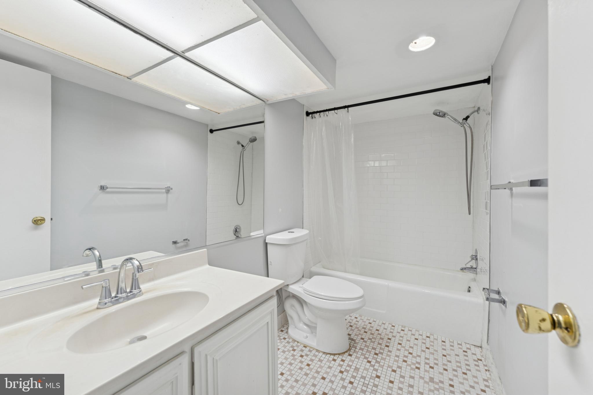 6100 Westchester Park Drive, Unit 520 College Park, MD 20740 - Photo 11 of 15 a bathroom with a sink a toilet and shower