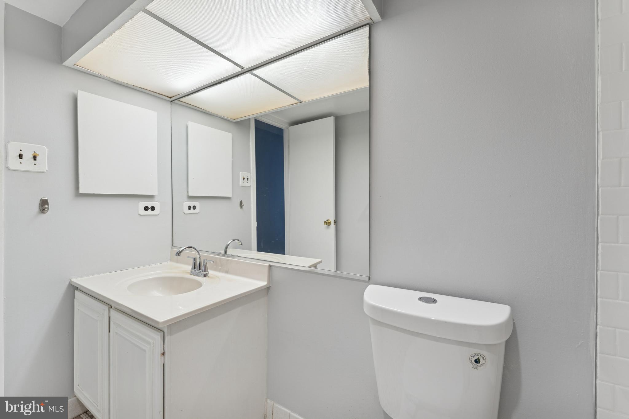 6100 Westchester Park Drive, Unit 520 College Park, MD 20740 - Photo 12 of 15 a bathroom with a sink a toilet and mirror