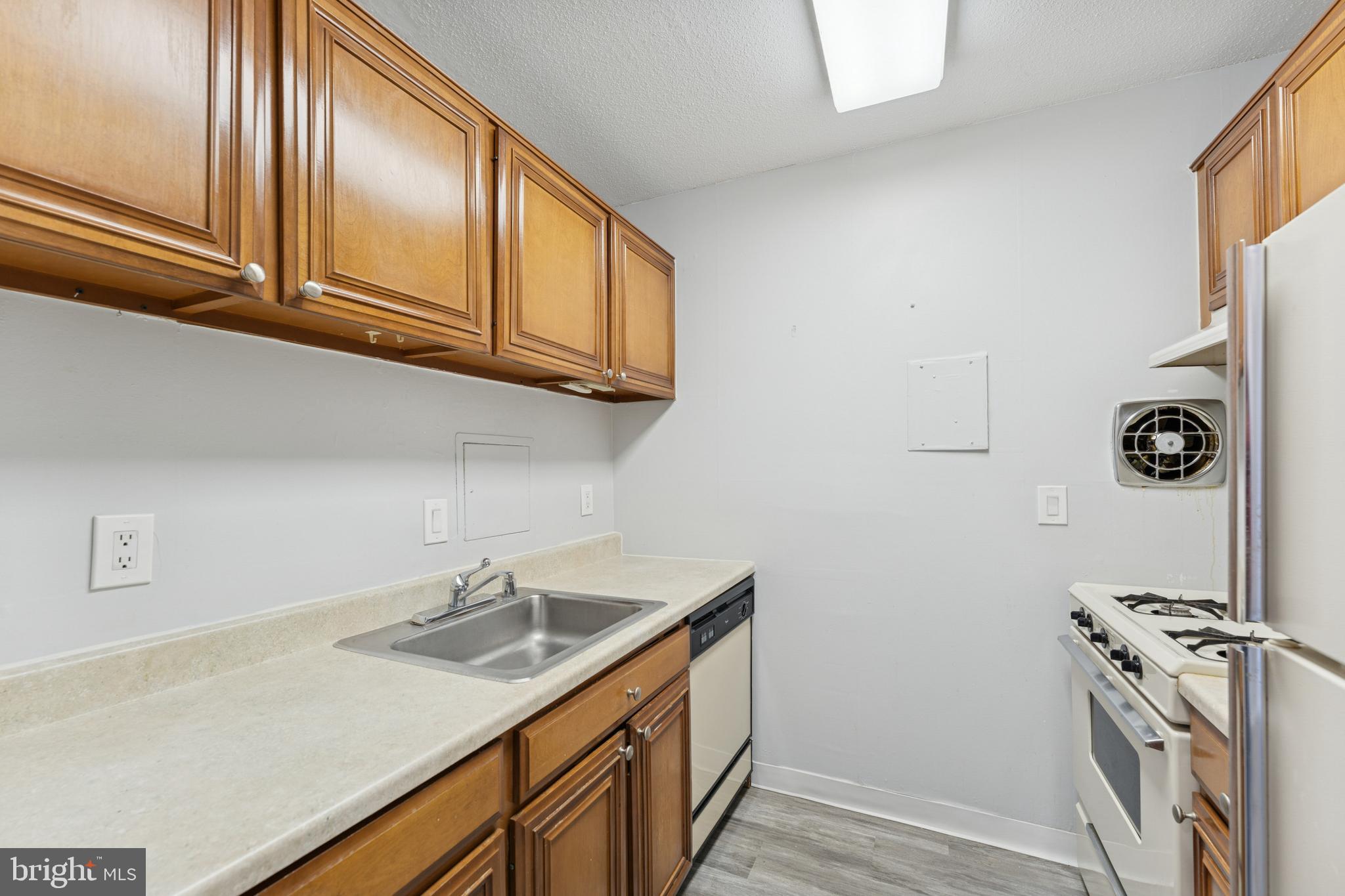6100 Westchester Park Drive, Unit 520 College Park, MD 20740 - Photo 5 of 15 a kitchen with stainless steel appliances granite countertop a sink and a stove