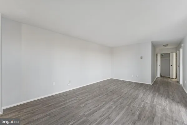 a view of an empty room and wooden floor