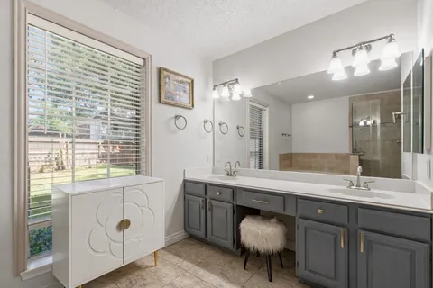 a bathroom with a double vanity sink and a bathtub