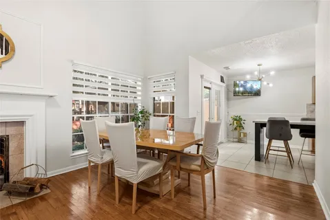 a dining room with furniture entryway and wooden floor