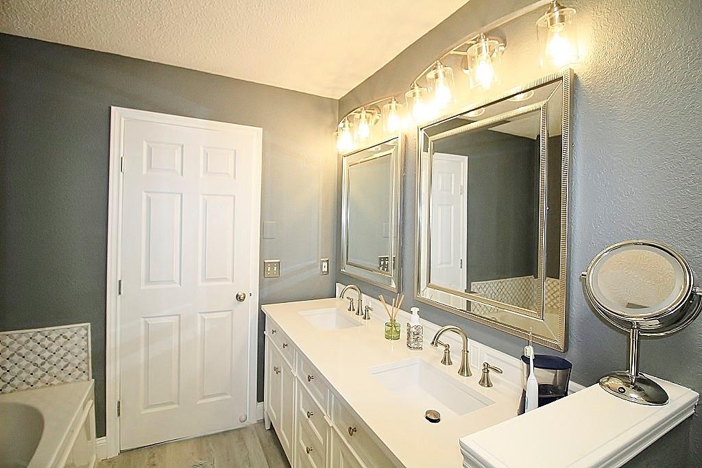 314 Pool Street Cedar Hill, TX 75104 - Photo 14 of 25 a bathroom with 2 sink and a mirror