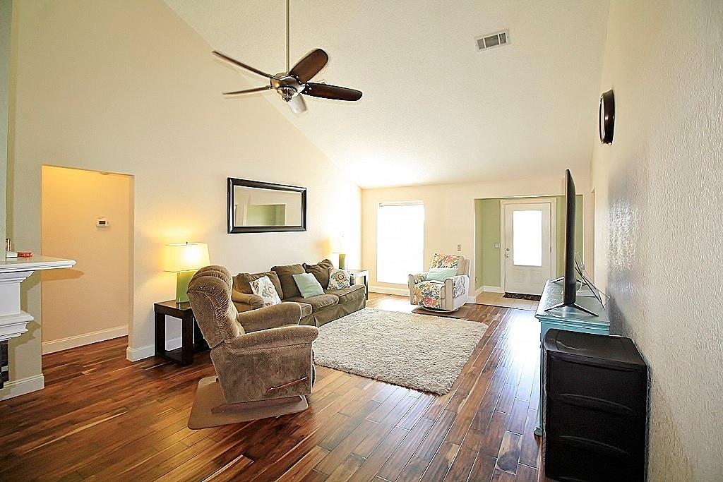 314 Pool Street Cedar Hill, TX 75104 - Photo 2 of 25 a living room with couches a coffee table and a chandelier with wooden floor