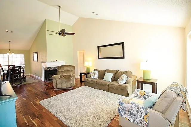 a living room with furniture a couch and wooden floor