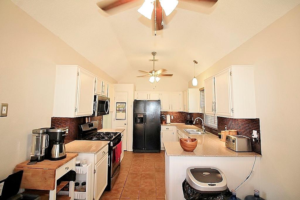 314 Pool Street Cedar Hill, TX 75104 - Photo 6 of 25 a kitchen with refrigerator a sink dishwasher and a stove with wooden floor