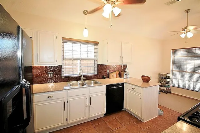 a kitchen that has a sink a stove and a window