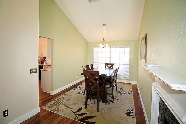 a view of a dining room with furniture and window