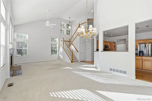 a view of a hallway with entryway chandelier and windows