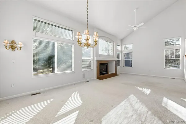 a view of livingroom with window fireplace and chandelier