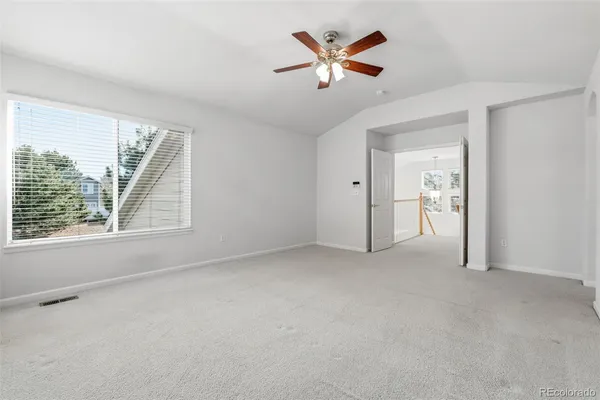 an empty room with a empty space and a ceiling fan