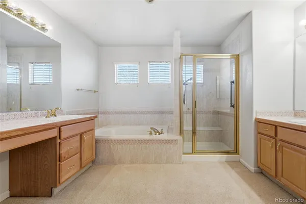a spacious bathroom with a tub sink shower and mirror