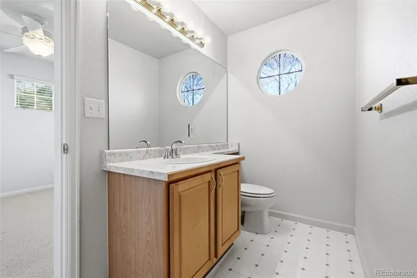 a bathroom with a sink a toilet and a mirror