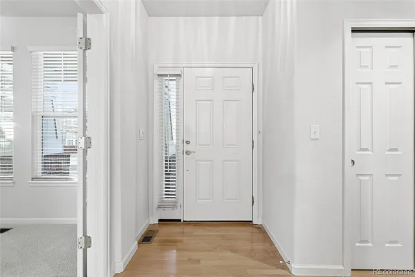 a view of an entryway with wooden floor