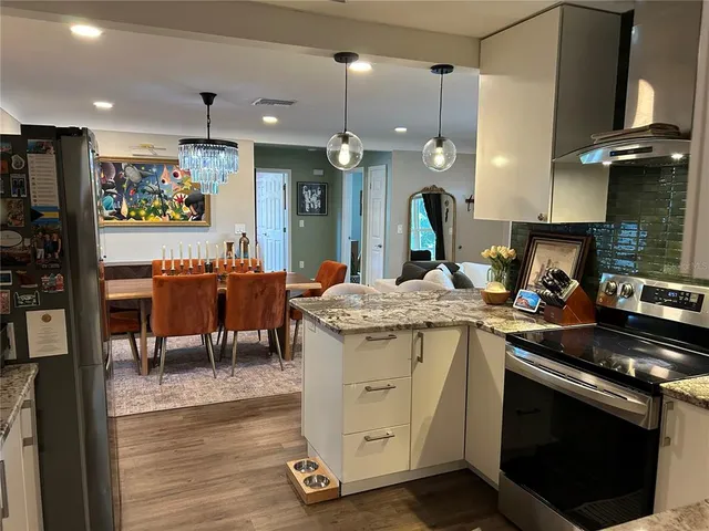 a kitchen with a sink appliances and cabinets