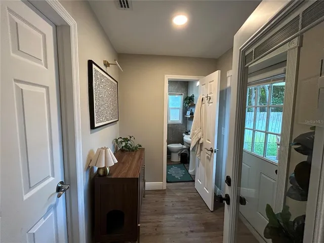 a view of a hallway with workspace and living room