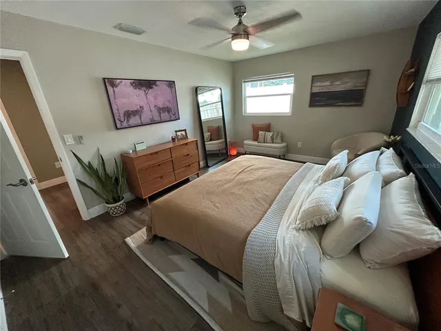 a bedroom with a bed and a flat screen tv
