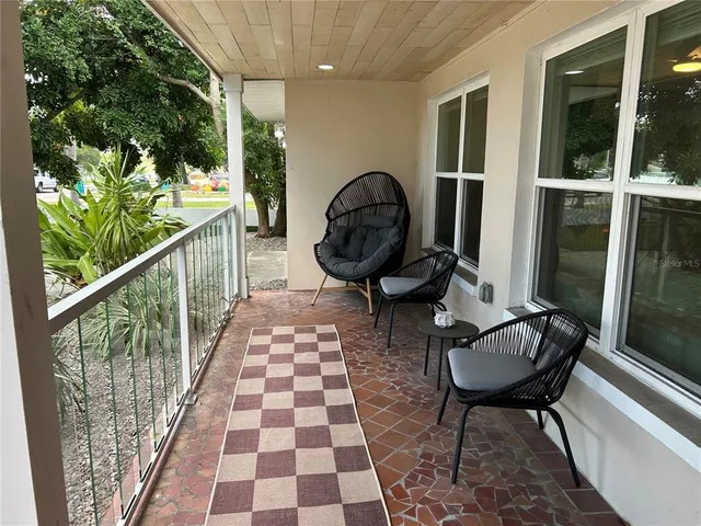 a view of a balcony with chairs