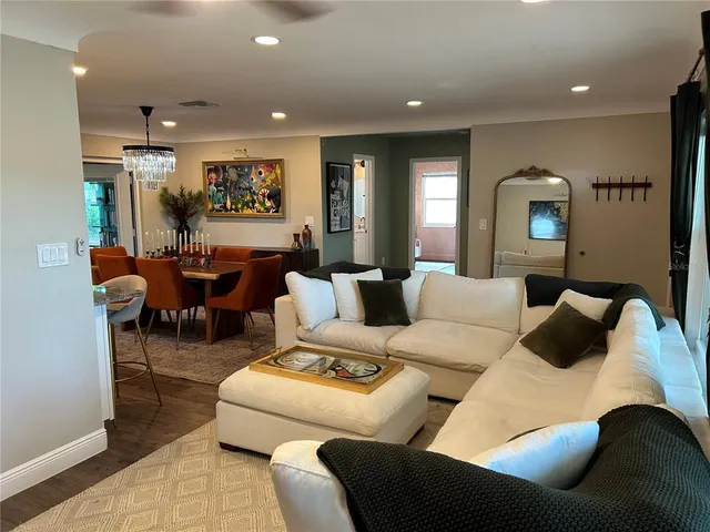 a living room with furniture and a mirror