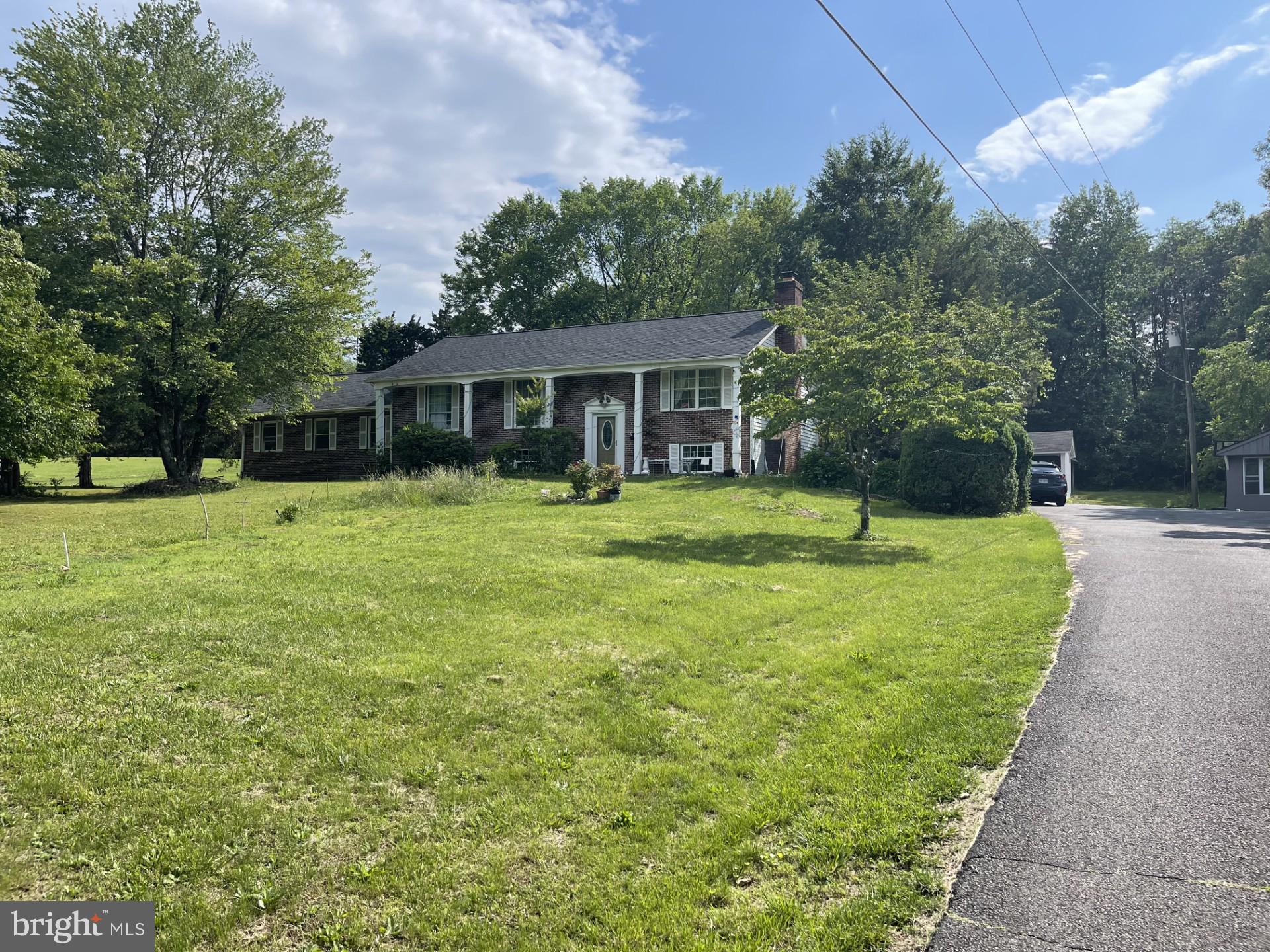 12574 Bristow Road Nokesville, VA 20181 - Photo 1 of 38 a backyard of a house with yard and green space