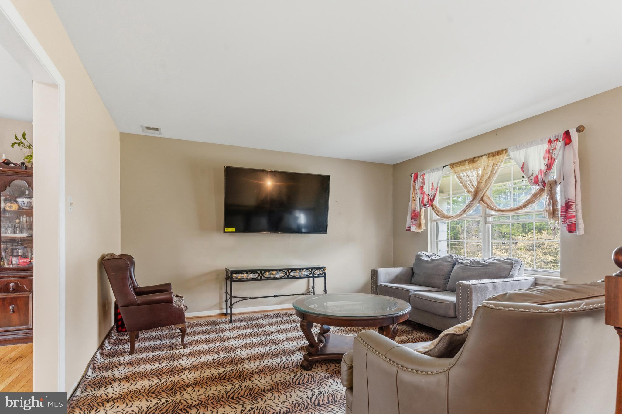 12574 Bristow Road Nokesville, VA 20181 - Photo 11 of 38 a living room with furniture and a flat screen tv