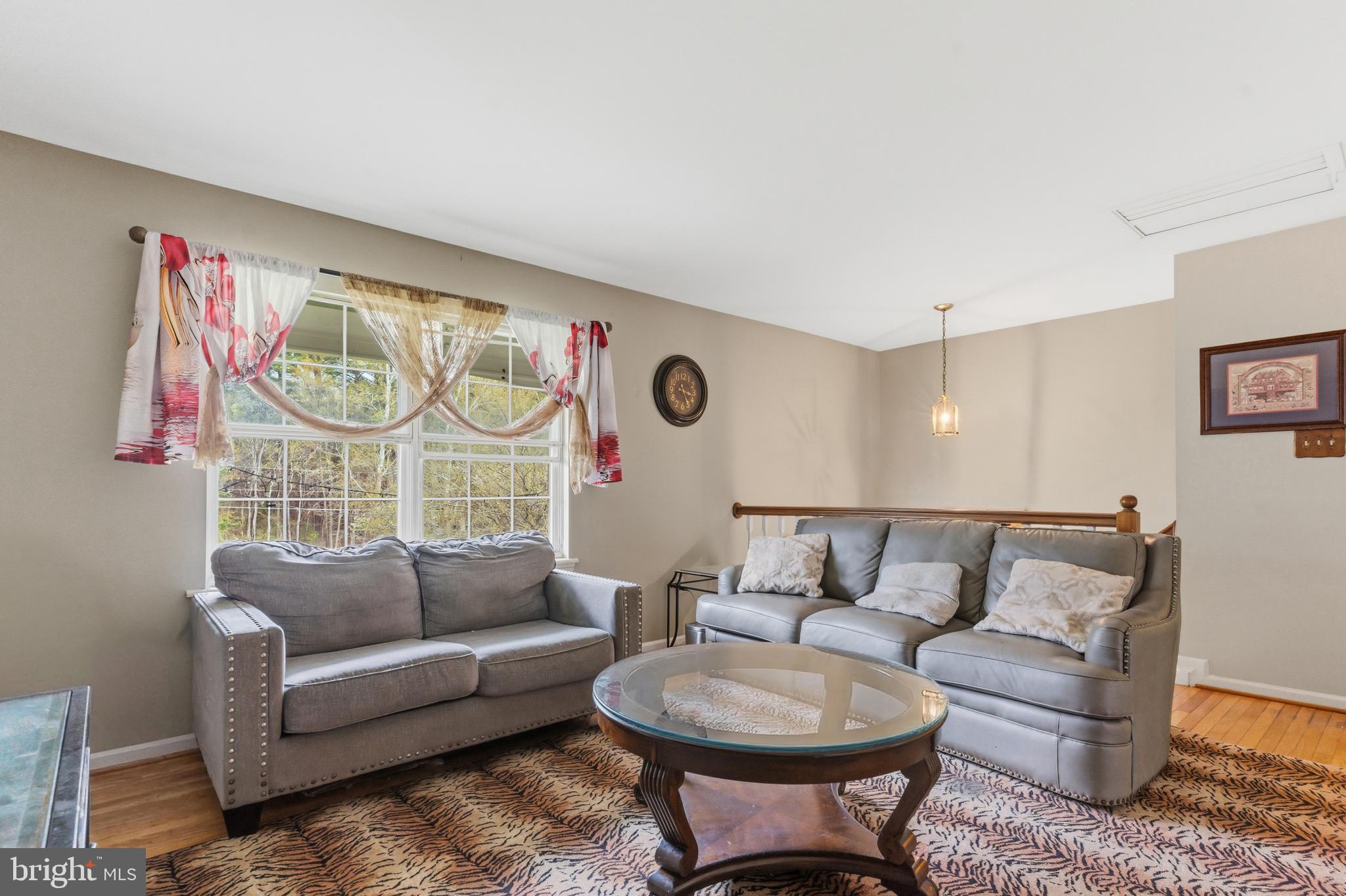 12574 Bristow Road Nokesville, VA 20181 - Photo 13 of 38 a living room with furniture a rug and a large window