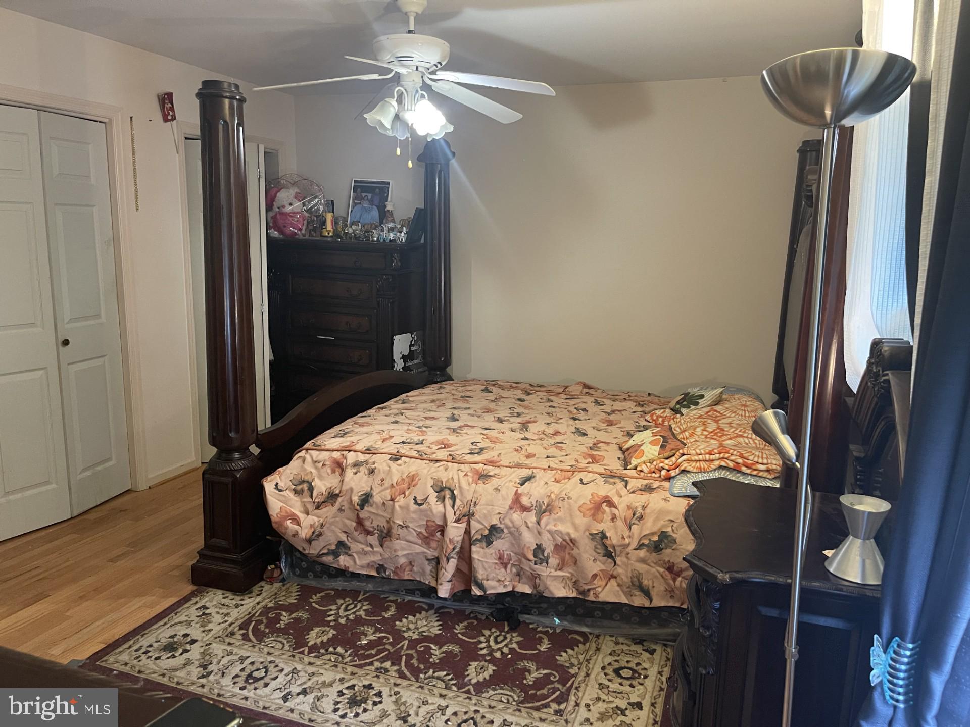 12574 Bristow Road Nokesville, VA 20181 - Photo 14 of 38 a bedroom with a bed and a chandelier
