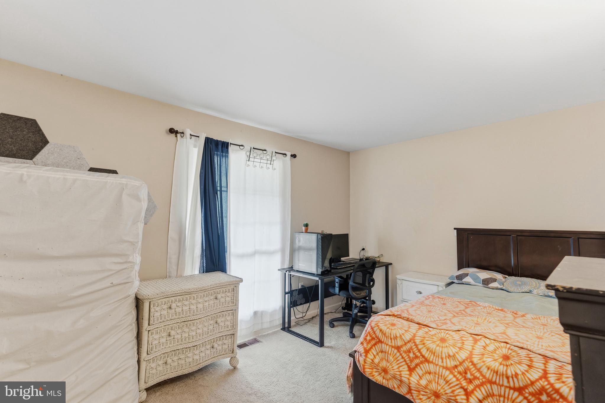 12574 Bristow Road Nokesville, VA 20181 - Photo 22 of 38 a bedroom with a bed and a table in it