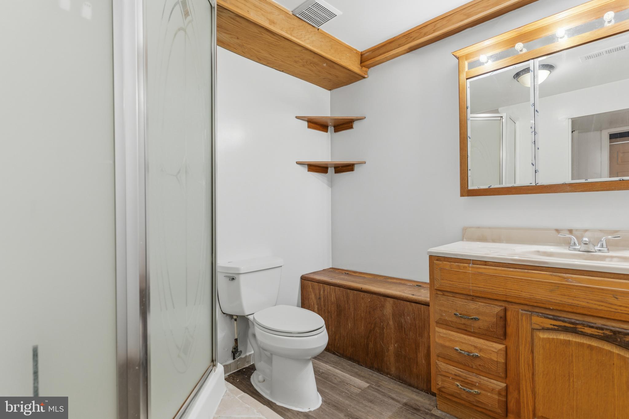 12574 Bristow Road Nokesville, VA 20181 - Photo 29 of 38 a bathroom with a toilet a sink and mirror